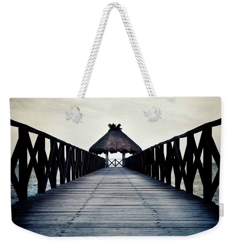 Water's Edge Weekender Tote Bag featuring the photograph The Dark Jetty by Mmeemil