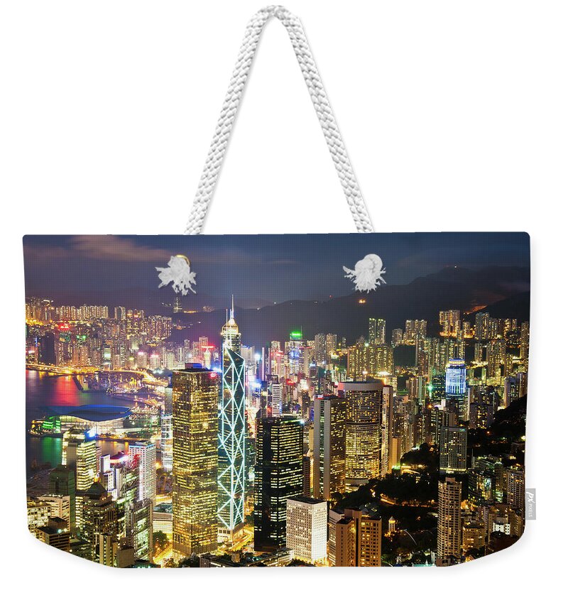 Population Explosion Weekender Tote Bag featuring the photograph The Lights Of Hong Kong Seen Fromthe by Tom Bonaventure
