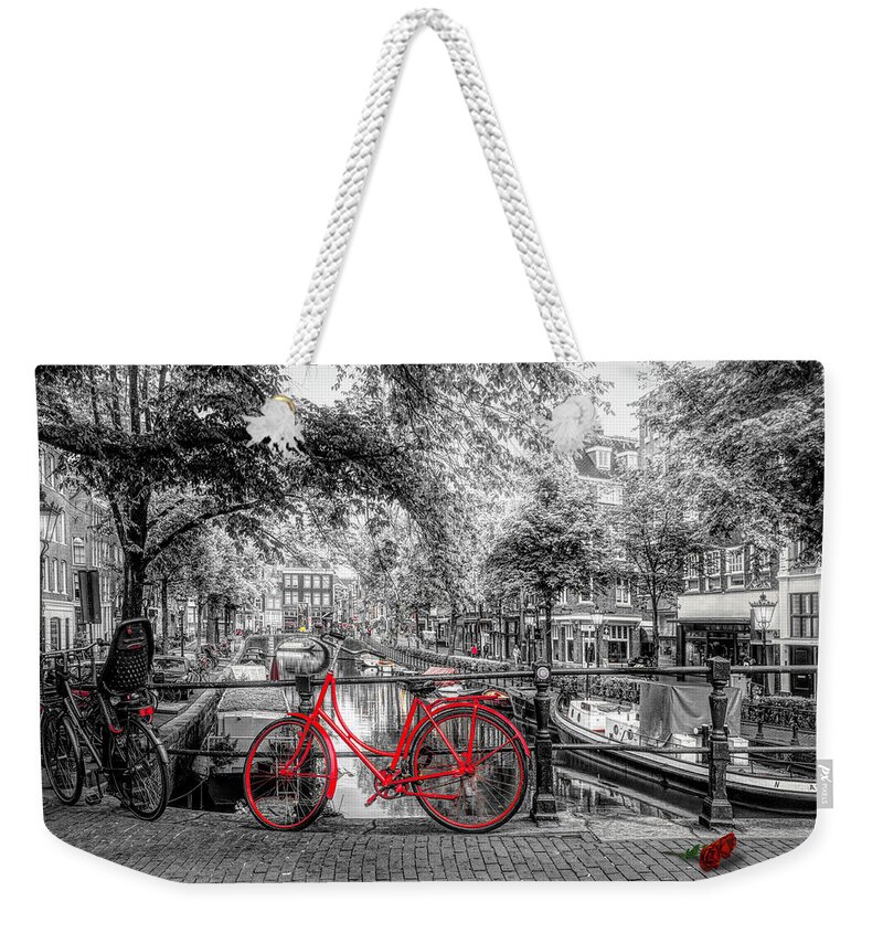 Boats Weekender Tote Bag featuring the photograph The Red Bike in Amsterdam in Color Selected Black and White by Debra and Dave Vanderlaan
