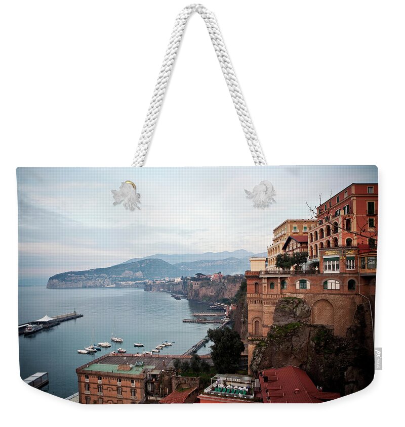 Tranquility Weekender Tote Bag featuring the photograph The Town Of Sorrento, Italy Hugs The by Chris Bennett