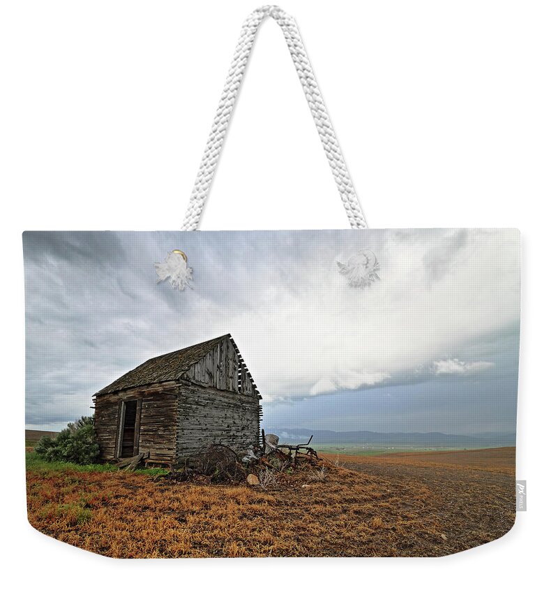 Idaho Weekender Tote Bag featuring the photograph Thompson Road Cabin and Storm - Downey, Idaho by Brett Pelletier