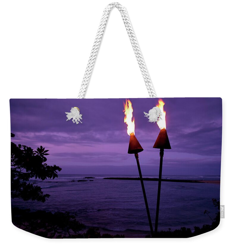 Scenics Weekender Tote Bag featuring the photograph Tiki Torches In Hawaii At Sunset by Skodonnell