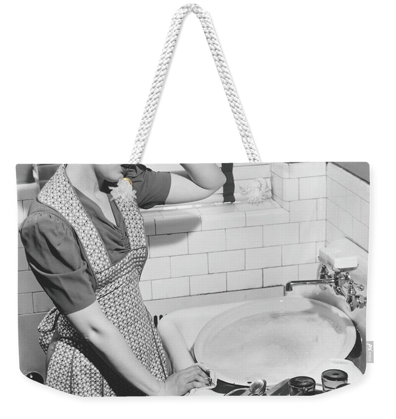 Three Quarter Length Weekender Tote Bag featuring the photograph Tired Woman At Kitchen Sink, B&w by George Marks