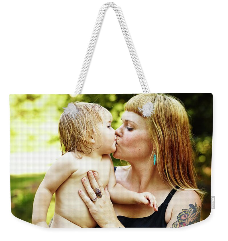 People Weekender Tote Bag featuring the photograph Toddler Daughter Being Kissed And Held by Thomas Barwick