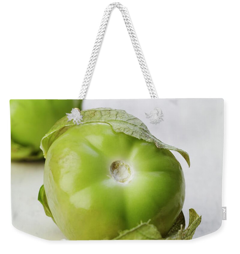 Two Objects Weekender Tote Bag featuring the photograph Tomatillos by James And James