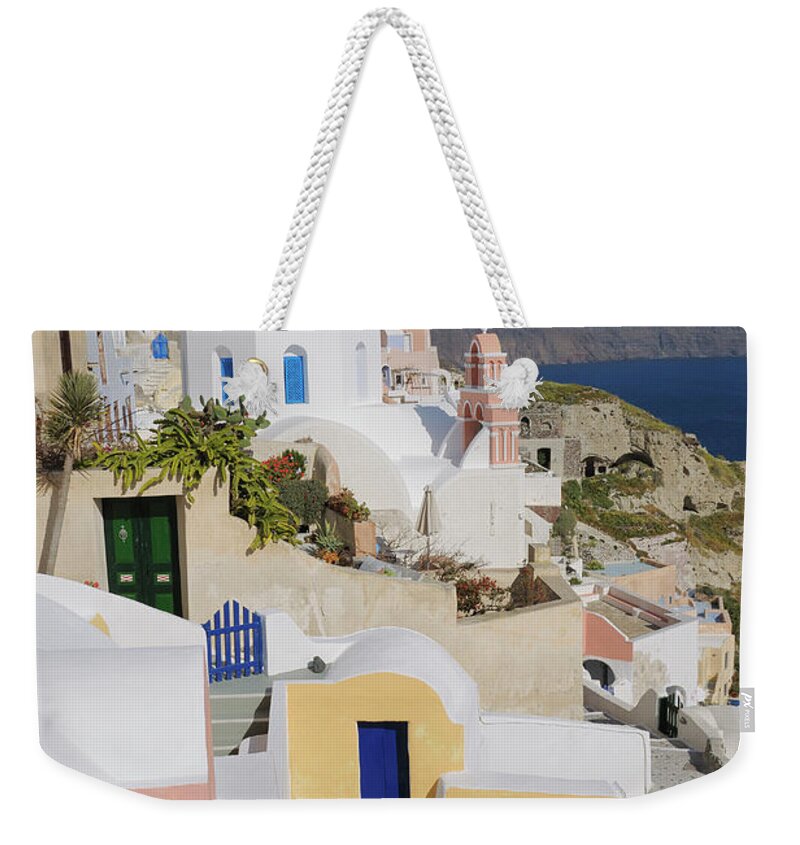 Greek Culture Weekender Tote Bag featuring the photograph Traditional Greek Houses And Curch by Martin Ruegner