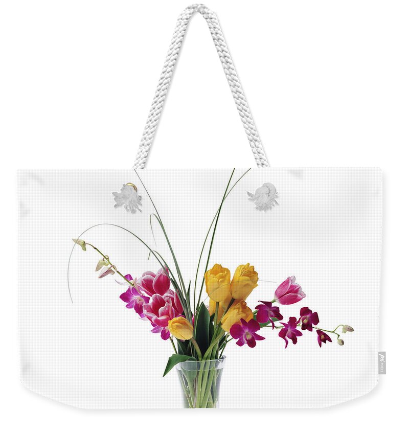White Background Weekender Tote Bag featuring the photograph Tulips And Dendrobium Orchids In A Vase by C Squared Studios