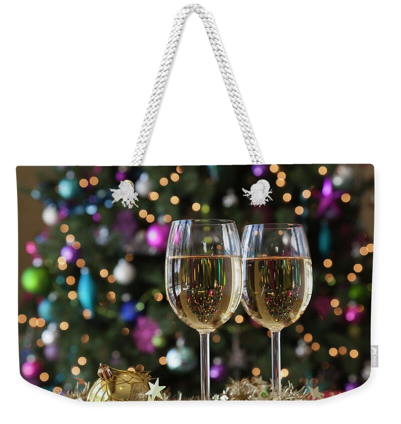 Alcohol Weekender Tote Bag featuring the photograph Two Glasses Of White Wine By Christmas by Juan Silva