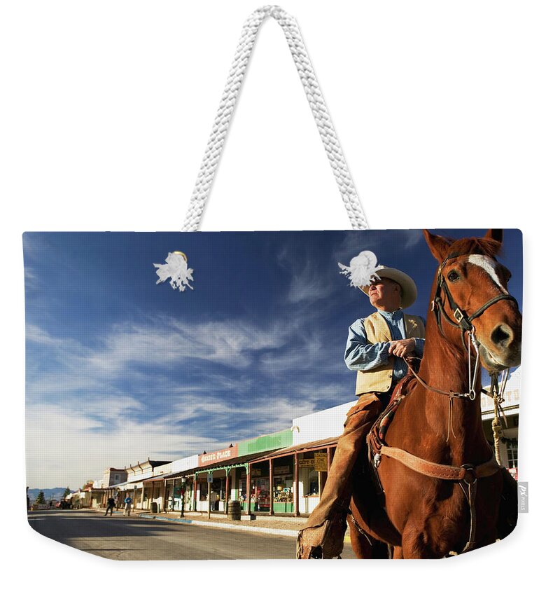 Horse Weekender Tote Bag featuring the photograph Usa, Arizona, Tombstone, Mature Cowboy by Walter Bibikow