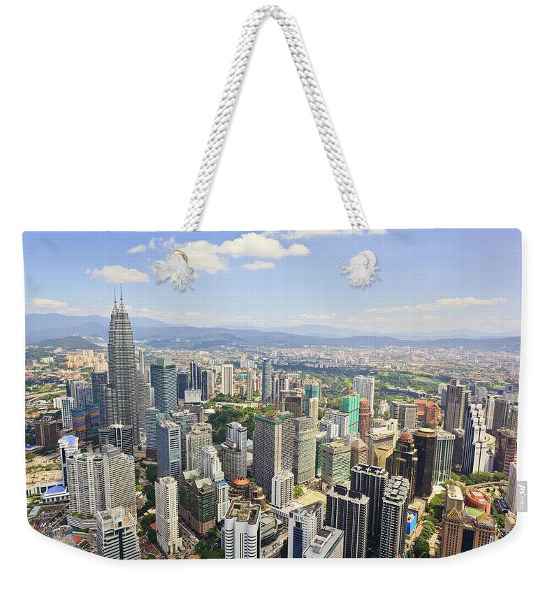 Outdoors Weekender Tote Bag featuring the photograph View Of The Kuala Lumpur Skyline by Tom Bonaventure