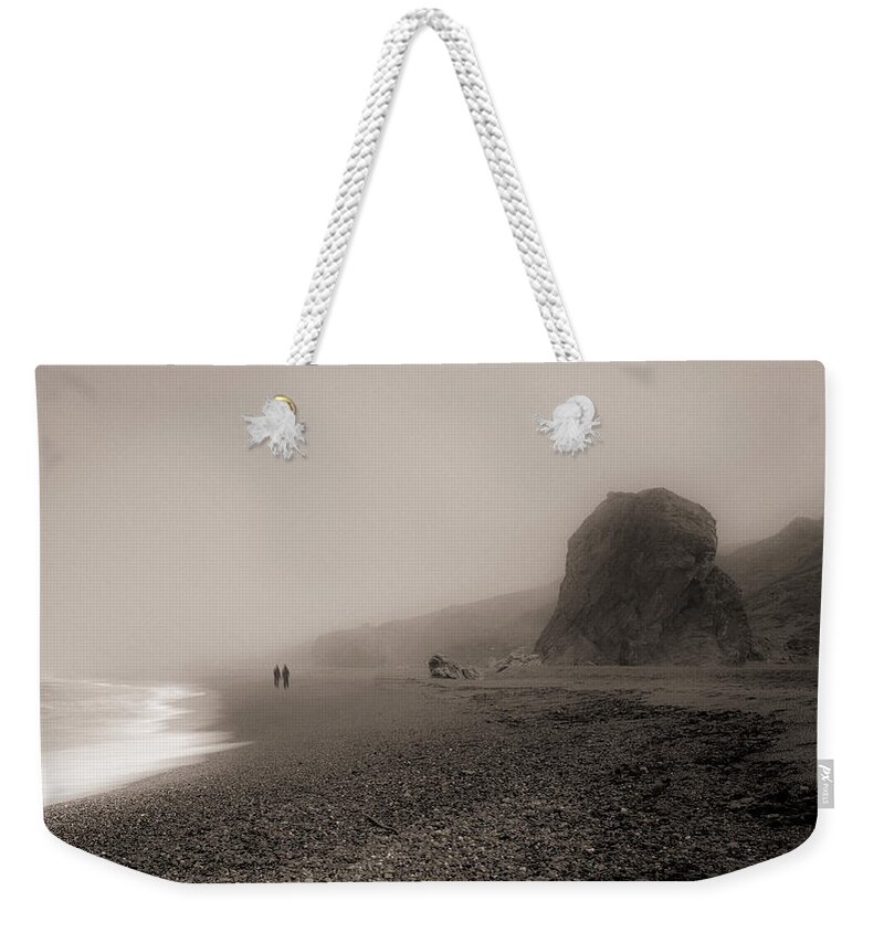 Goat Rock Weekender Tote Bag featuring the photograph Two walking on the beach by Alessandra RC