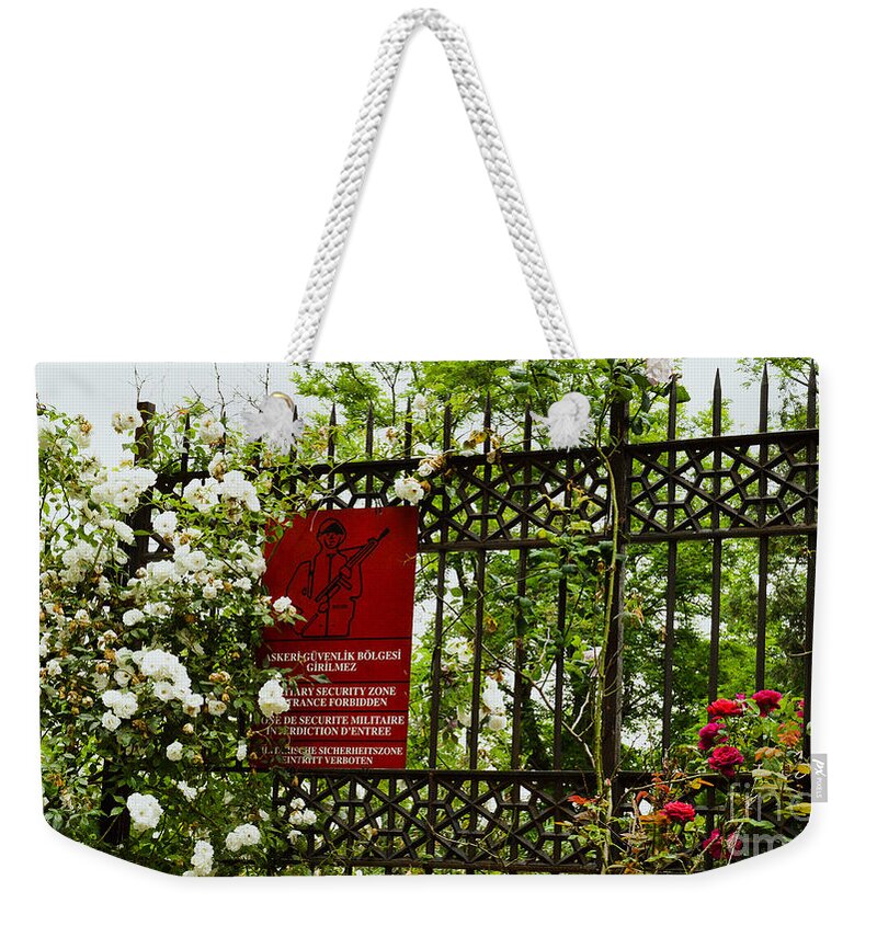Fences Weekender Tote Bag featuring the photograph When the roses won the war by Yavor Mihaylov