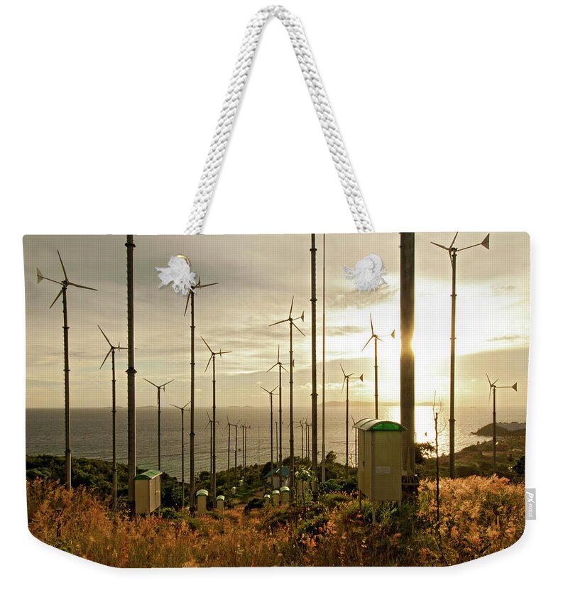 Environmental Conservation Weekender Tote Bag featuring the photograph Winn Turbine In Sunset by Kampee Patisena