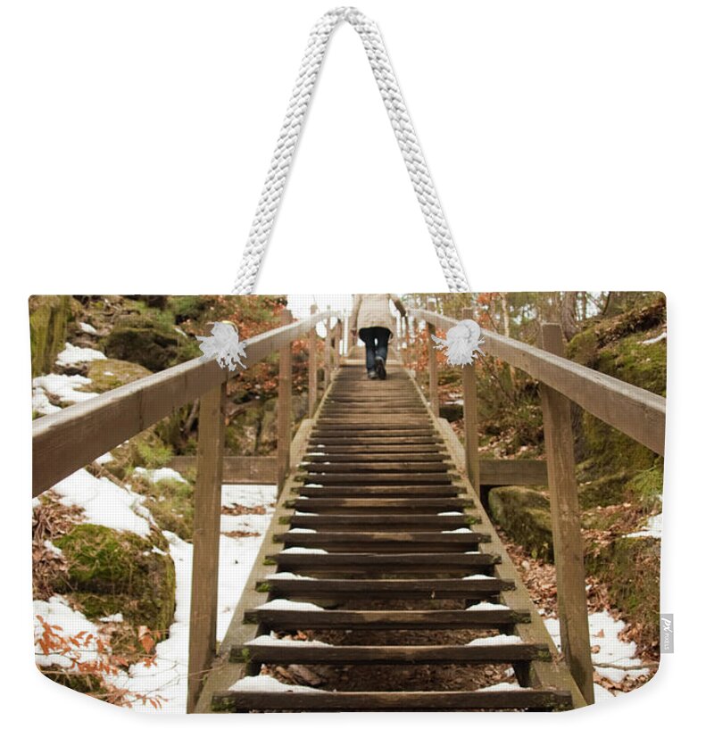 People Weekender Tote Bag featuring the photograph Woman Going Up Icy Stairs by Carlos Ciudad Photos