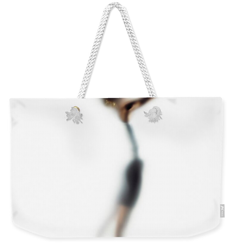 White Background Weekender Tote Bag featuring the photograph Woman Shooting Basketball, Side View by Symphonie