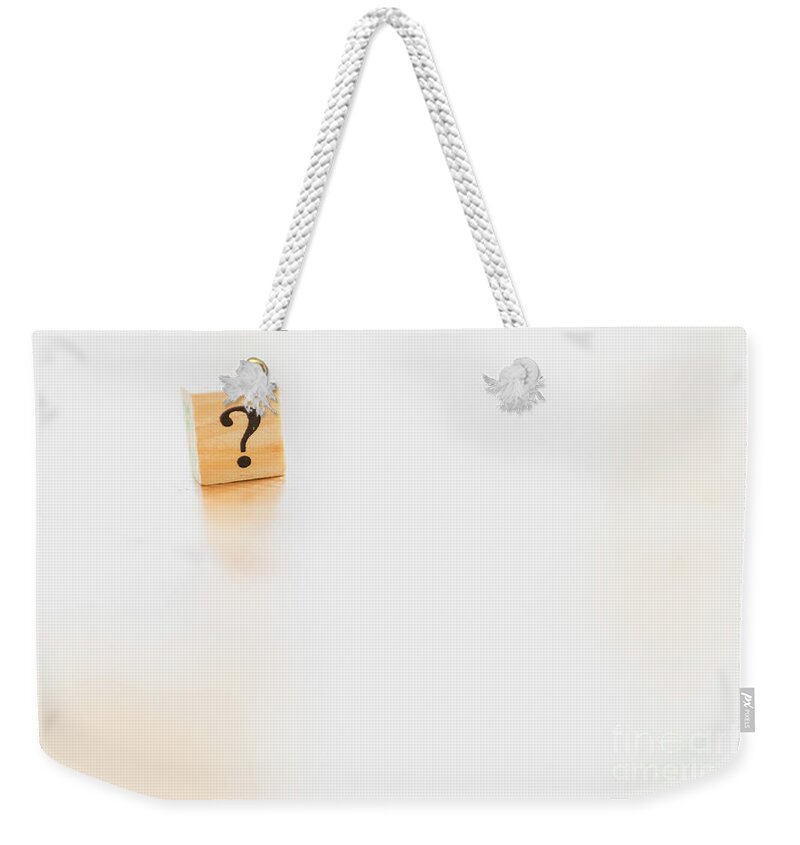 Abstract Weekender Tote Bag featuring the photograph Wooden dice with question mark and doubt. by Joaquin Corbalan