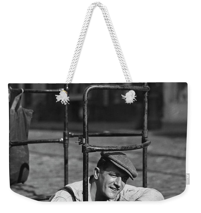 People Weekender Tote Bag featuring the photograph Worker Climbing Into Manhole by George Marks