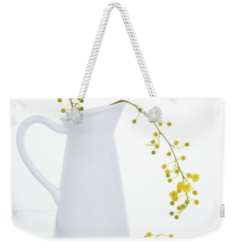 Decoration Weekender Tote Bag featuring the photograph Yellow beautiful flowers on a white vase. by Michalakis Ppalis