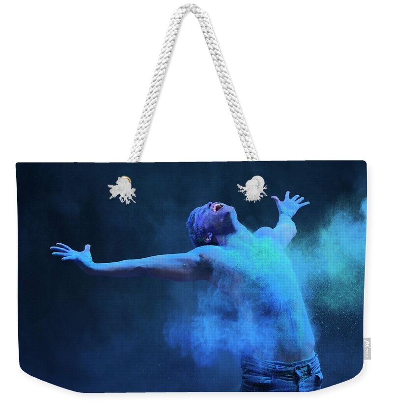 Art Weekender Tote Bag featuring the photograph Young Man In Spray Of Colored Powder by Henrik Sorensen