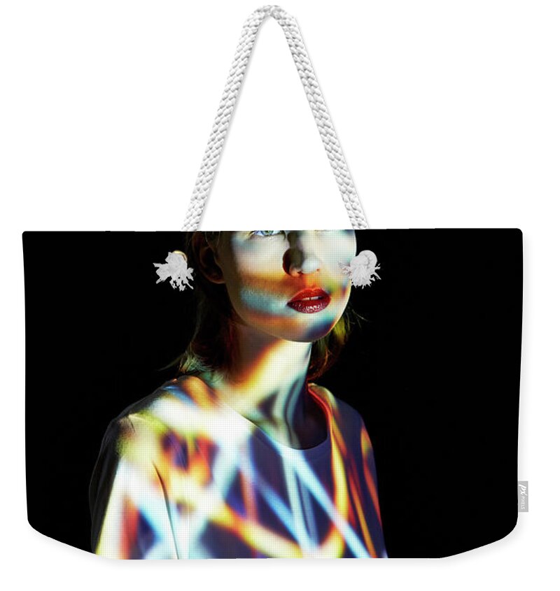 People Weekender Tote Bag featuring the photograph Young Woman Covered In Multicolored by Mads Perch