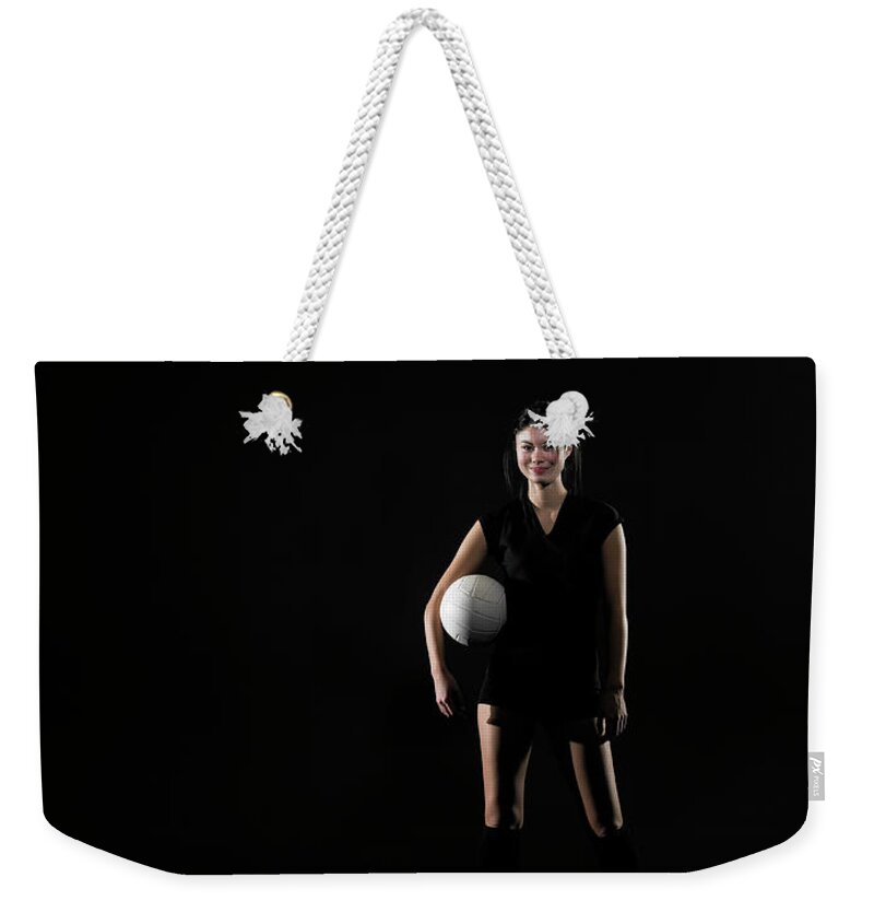 Caucasian Ethnicity Weekender Tote Bag featuring the photograph Young Woman Holding Volleyball, Portrait by Thomas Barwick