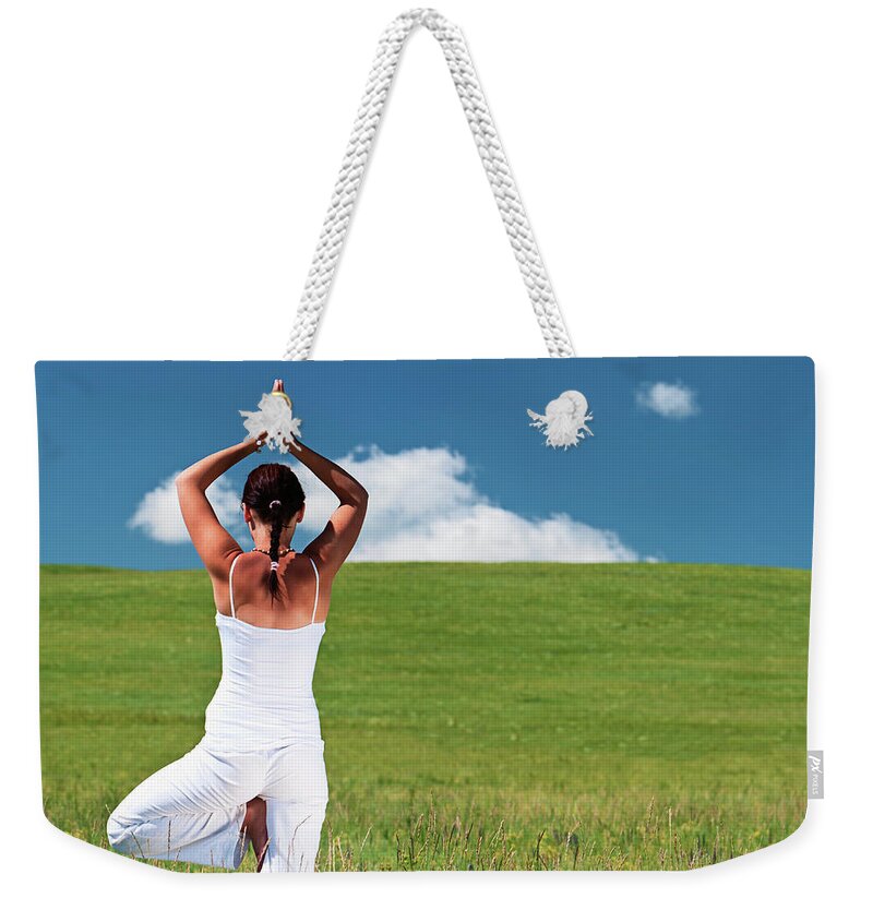 Scenics Weekender Tote Bag featuring the photograph Young Woman Practicing Yoga by Hadynyah