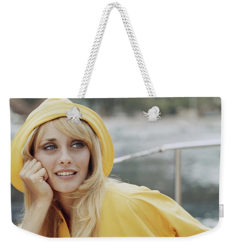 Hooded Shirt Weekender Tote Bag featuring the photograph Young Woman Wearing Hooded Top by Tom Kelley Archive