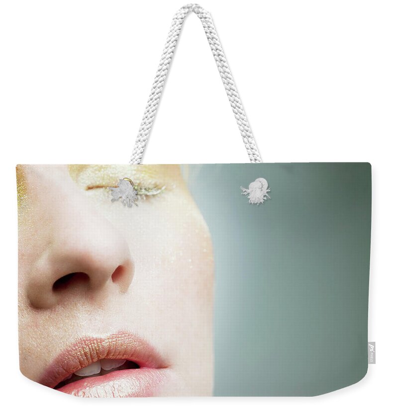 People Weekender Tote Bag featuring the photograph Young Woman With Gold Make Up On Face by Image Source