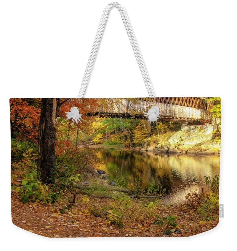 The Gorgeous Henniker Covered Bridge On A Beautiful Fall Day In October Seen Throuh The Woods. Henniker Weekender Tote Bag featuring the photograph Covered Bridge in Autumn #1 by Donna Doherty
