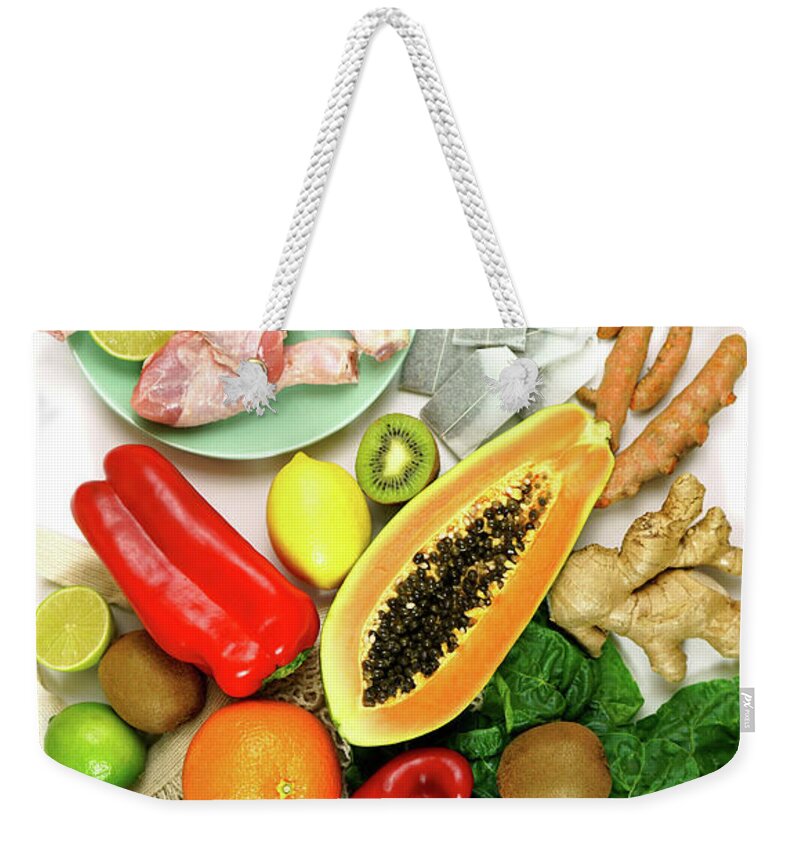 Food Weekender Tote Bag featuring the photograph Foods that boost the Immune System including fruit, vegetables and poultry. #1 by Milleflore Images