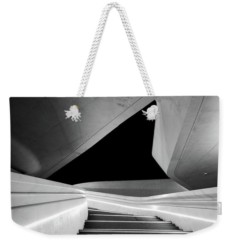 Futuristic Building Weekender Tote Bag featuring the photograph Modern architecture and empty staircase leading to a bright open space. by Michalakis Ppalis