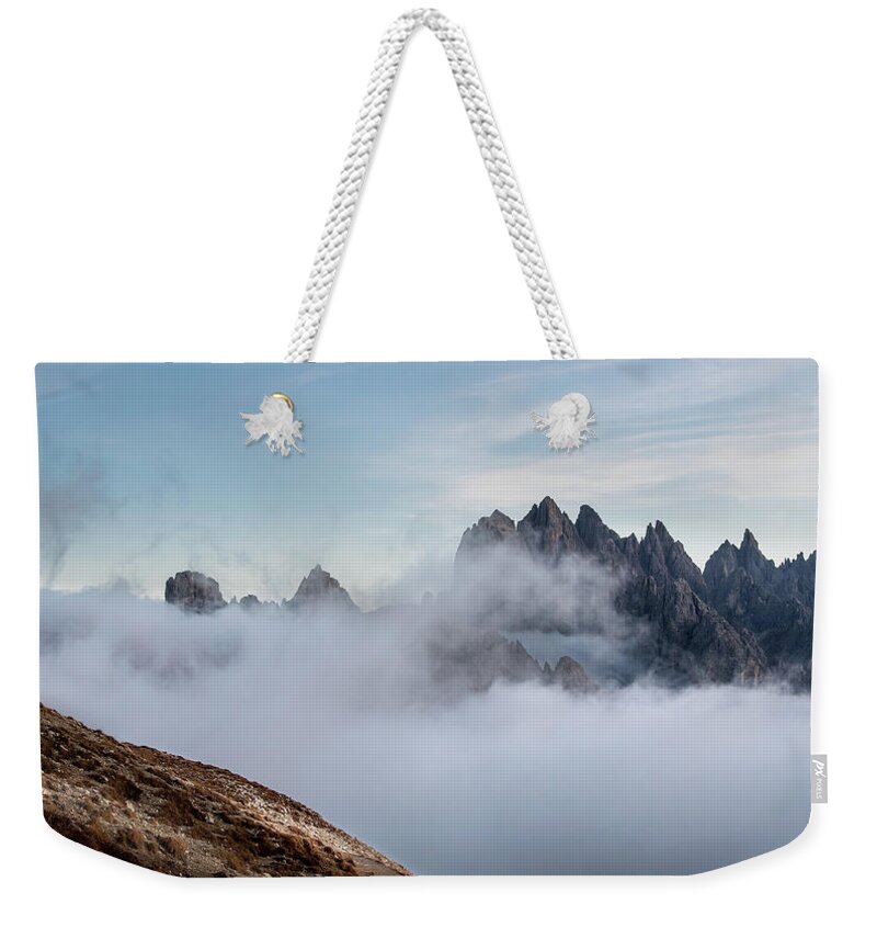 Italian Alps Weekender Tote Bag featuring the photograph Mountain landscape with fog in autumn. Tre Cime dolomiti Italy. by Michalakis Ppalis