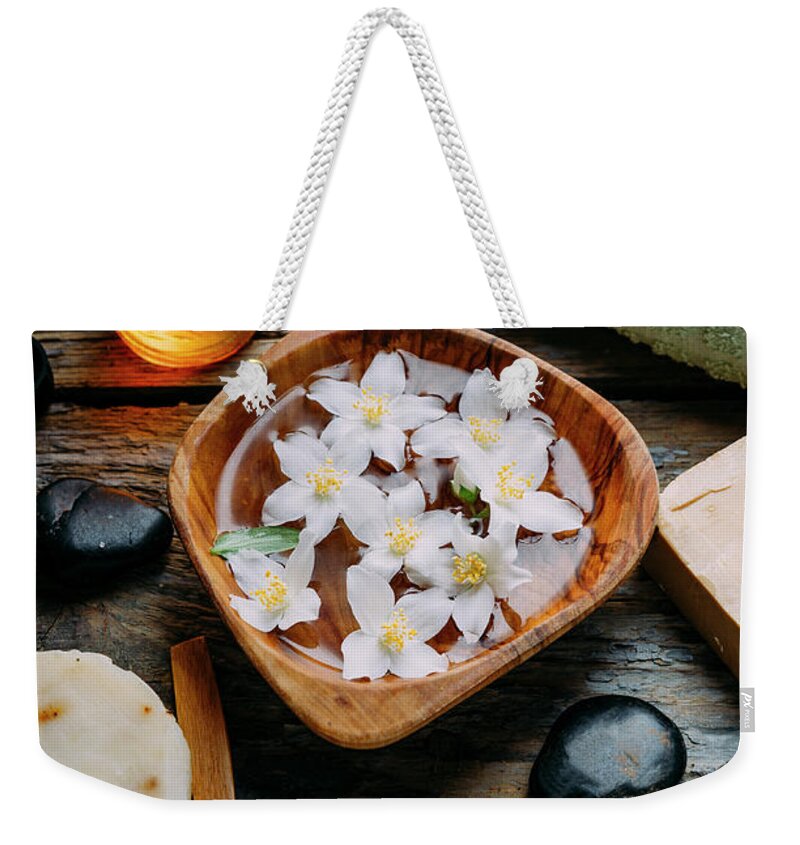 Spa Weekender Tote Bag featuring the photograph Natural spa cosmetics with essential massage oils, jasmine flowe #1 by Jelena Jovanovic