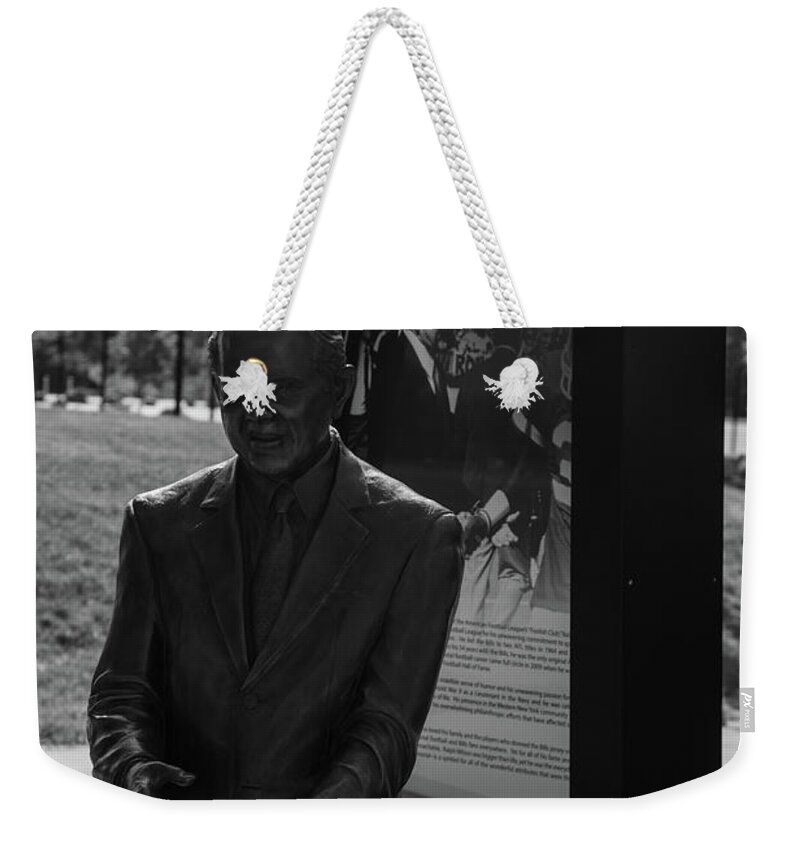 Buffalo New York Weekender Tote Bag featuring the photograph Ralph Wilson statue at Buffalo Bills Stadium in black and white by Eldon McGraw