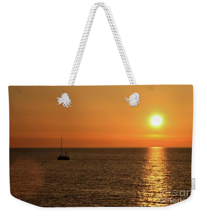 Sea Weekender Tote Bag featuring the photograph Sail boat cruises on Black Sea as sun sets on horizon Batumi Georgia #2 by Imran Ahmed