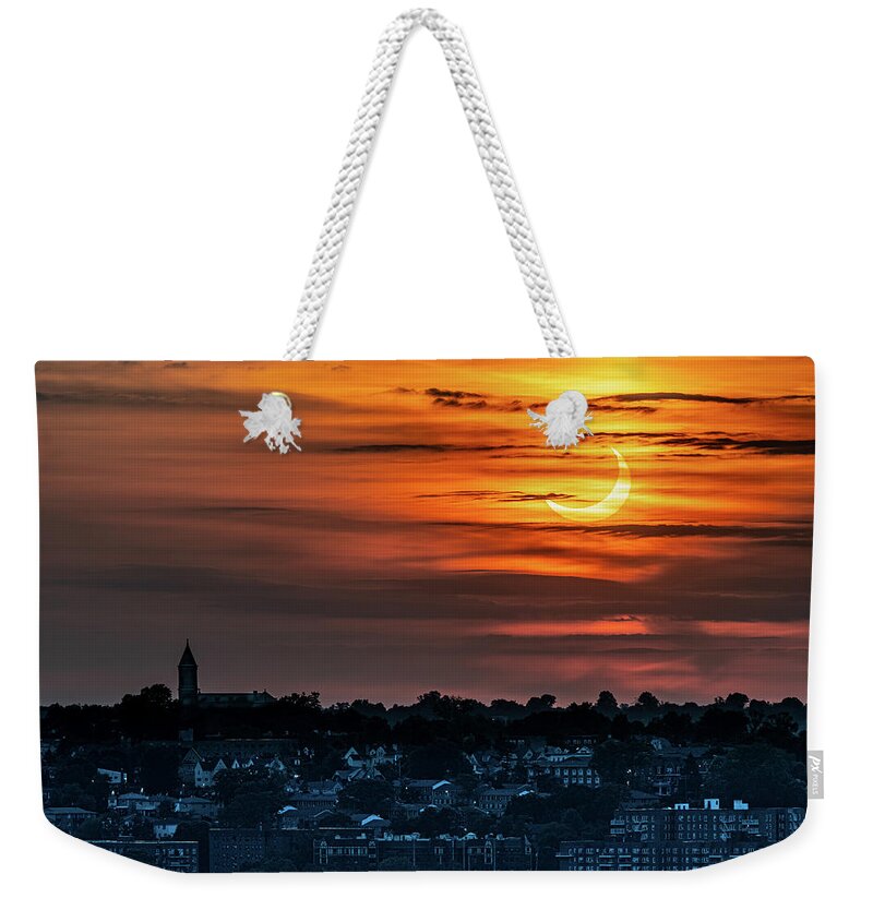 New York Weekender Tote Bag featuring the photograph Solar eclipse over Yonkers by Kevin Suttlehan