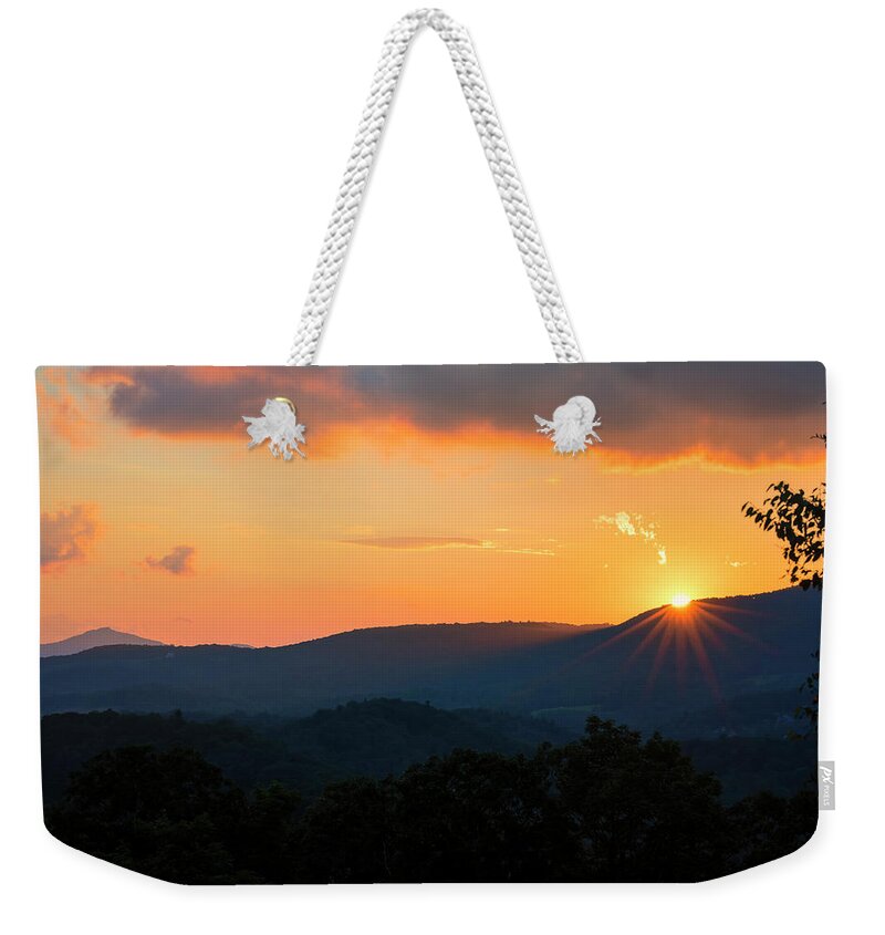 2017 Weekender Tote Bag featuring the photograph Sun Dips Below the Horizon #1 by Charles Floyd