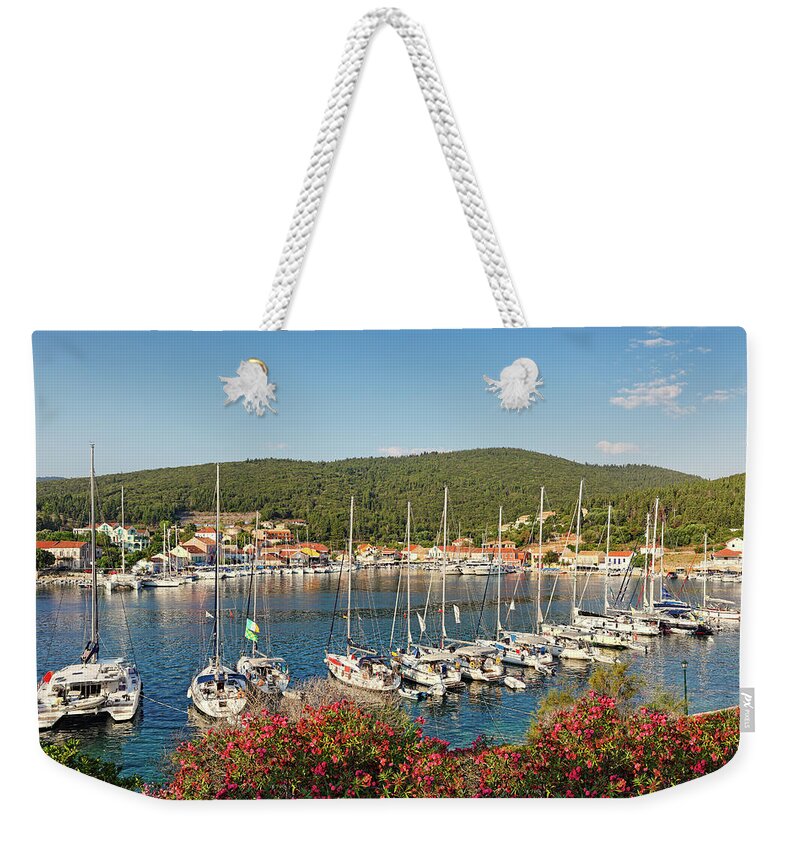 Fiscardo Weekender Tote Bag featuring the photograph The port of Fiskardo in Kefalonia, Greece #1 by Constantinos Iliopoulos