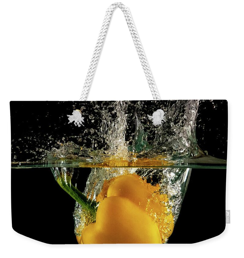 Pepper Weekender Tote Bag featuring the photograph Yellow bell pepper dropped and slashing on water by Michalakis Ppalis