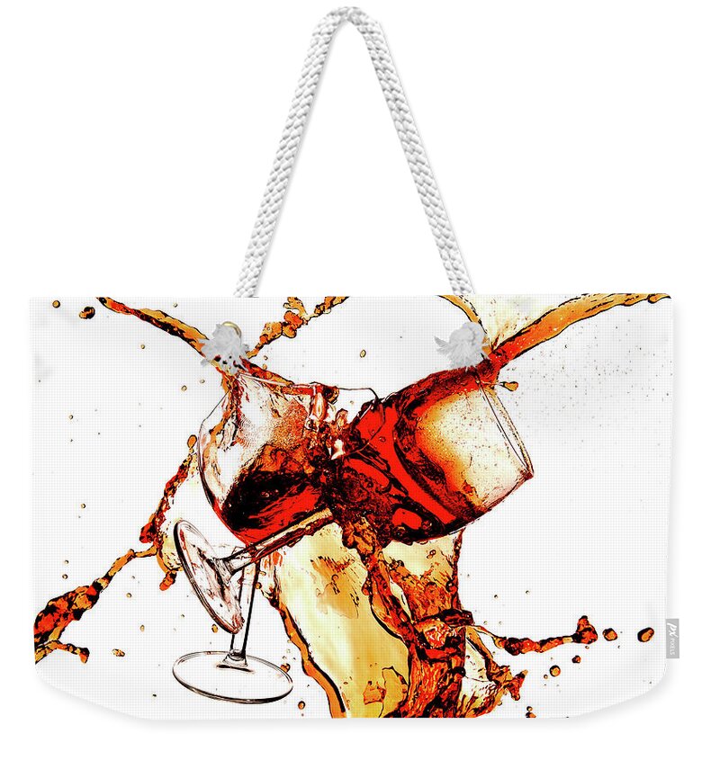 Damaged Weekender Tote Bag featuring the photograph Broken wine glasses with wine splashes on a white background by Michalakis Ppalis