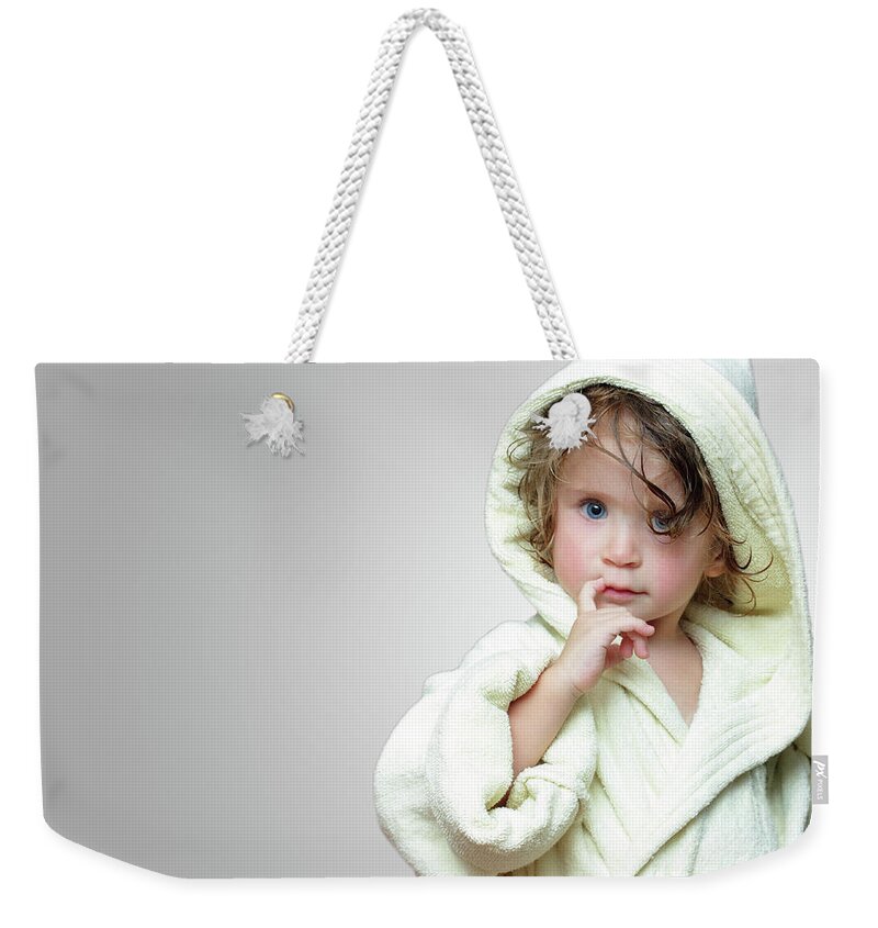 Childhood Weekender Tote Bag featuring the photograph Cute Girl In Bathrobe Portrait #3 by Mikhail Kokhanchikov