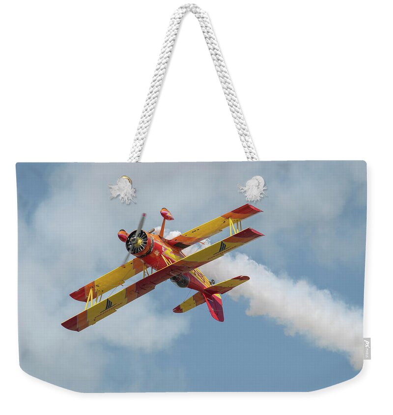 Red Weekender Tote Bag featuring the photograph Red and Yellow Airplane by Carolyn Hutchins