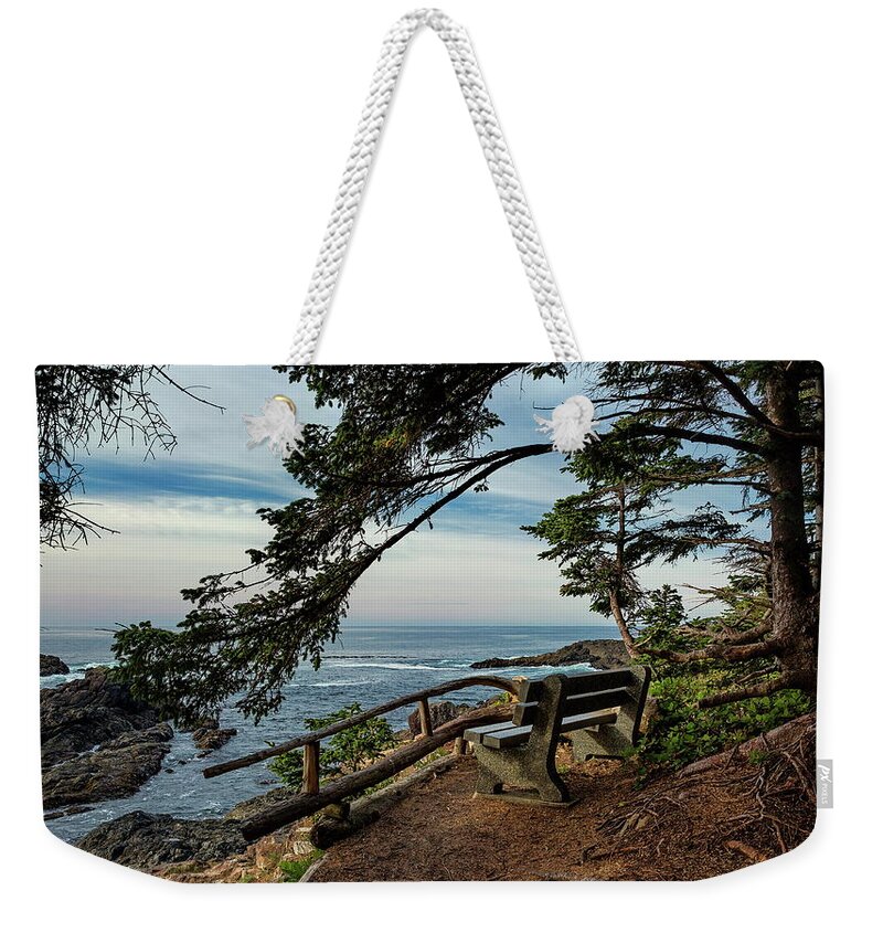 Alex Lyubar Weekender Tote Bag featuring the photograph A bench on the cliff over the seashore by Alex Lyubar
