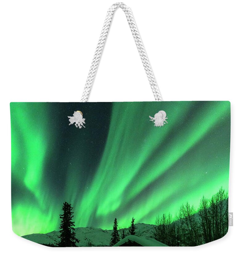 Aurora Weekender Tote Bag featuring the photograph A Cabin in the Lights by Laura Hedien