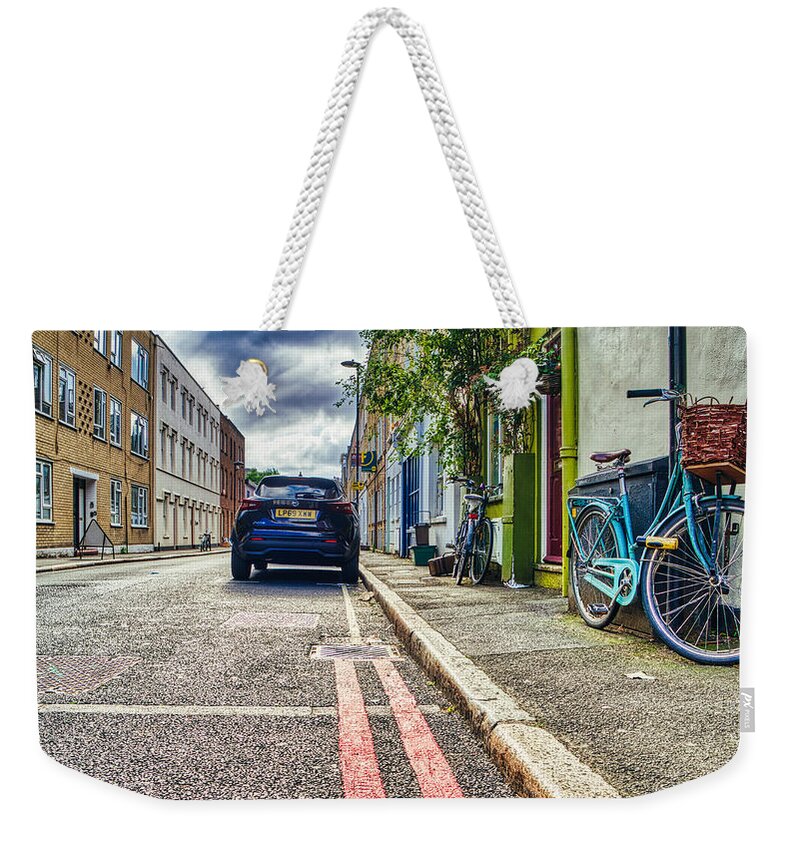 Camden Town London Weekender Tote Bag featuring the photograph A Camden Street by Raymond Hill