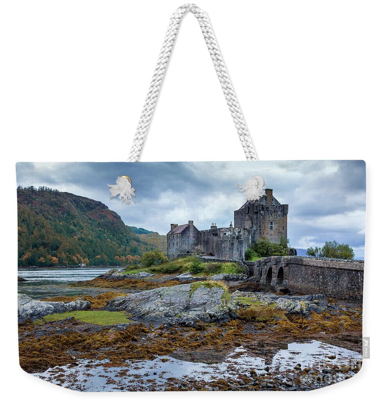 Castle Weekender Tote Bag featuring the photograph A storm brews over Eilean Donan Castle, Scotland by Jane Rix