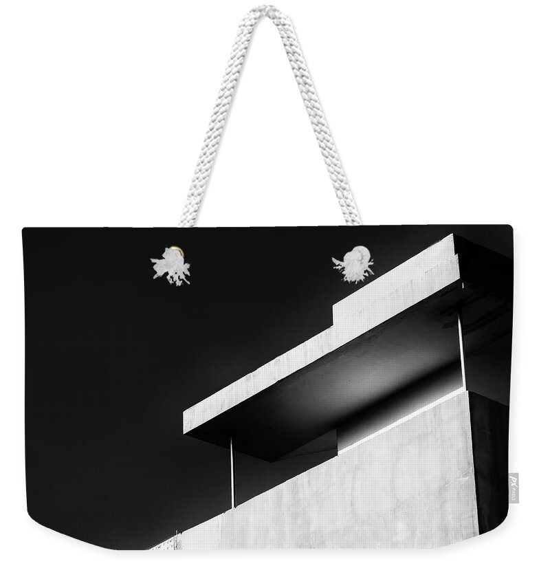 Black And White Weekender Tote Bag featuring the photograph Abstract architecture design. Black and white futuristic exterior background. Black sky copy-space by Michalakis Ppalis