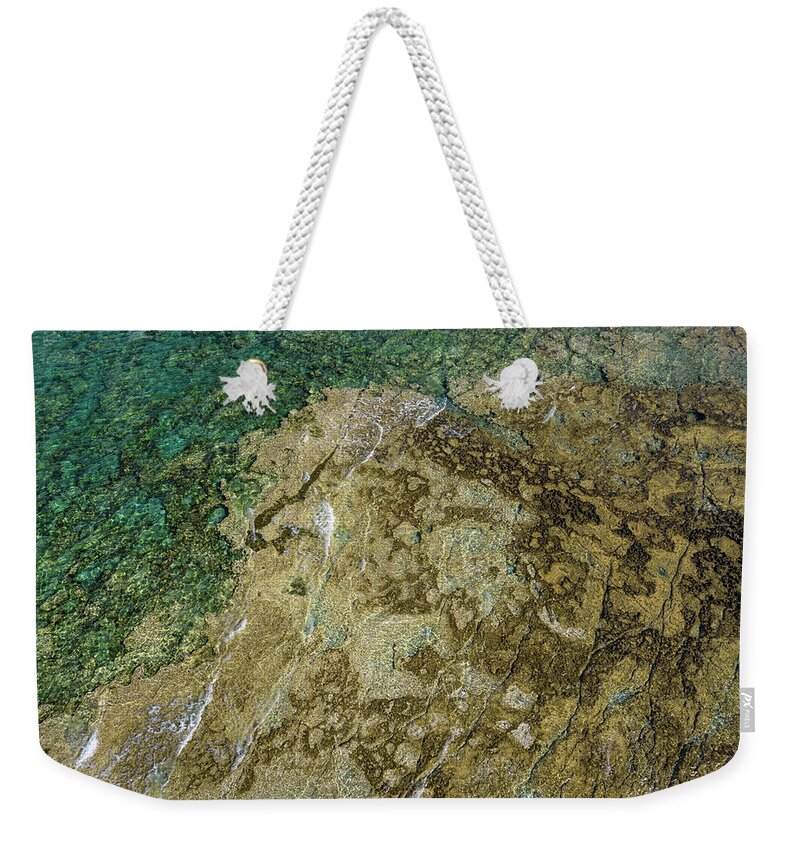 Seascape Weekender Tote Bag featuring the photograph Aerial drone view of sea transparent water with rocks on the bottom. Ocean background by Michalakis Ppalis