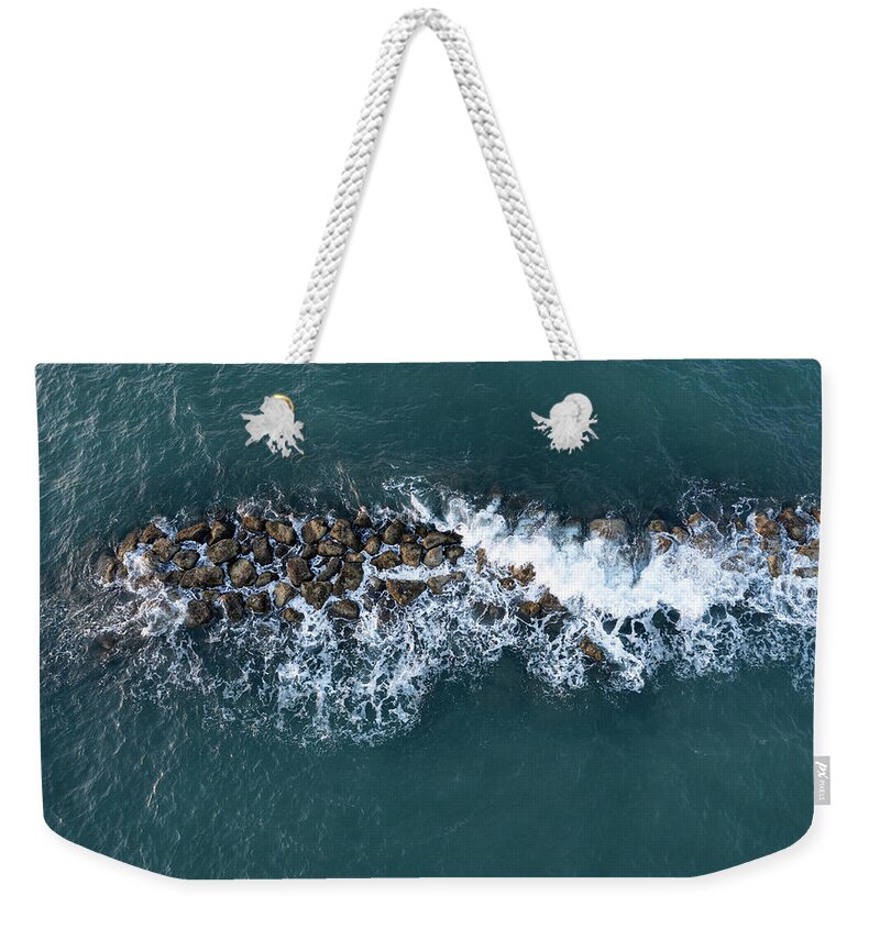 Ocean Weekender Tote Bag featuring the photograph Aerial view from a flying drone of blue sea water and break water. Sea wall coastline by Michalakis Ppalis