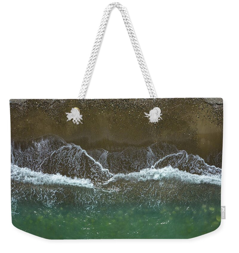 Waves Weekender Tote Bag featuring the photograph Aerial view ocean waves braking on a sandy beach. Nature background by Michalakis Ppalis